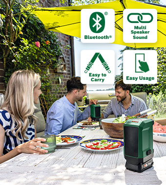 Bosch UniversalSpeaker 18V-1 Cordless Bluetooth Speaker – Multi-Speaker Sound, 3 Year Warranty Bosch UniversalSpeaker 18V-1 cordless Bluetooth speaker playing music at a garden dinner table, with Multi-Speaker Sound, easy-carry design and 3-year MyBosch warranty