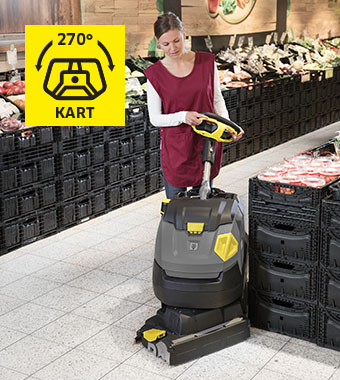 Rotating KART brush head cleans tight aisles and cluttered spaces Kärcher BR 45/22 C Bp Pro scrubber dryer cleaning a supermarket aisle between stacked crates using its rotating KART brush head