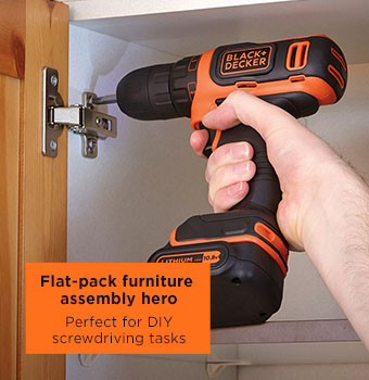 Black & Decker BDCDB12 10.8V Cordless Lithium-ion Drill Driver in use, illuminating a dark cabinet interior with its LED light while driving a screw for home assembly.