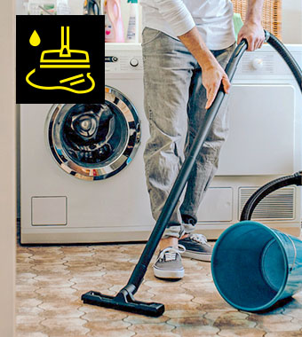 Kärcher WD 3 S Wet and Dry Vacuum Cleaner Man using the Kärcher WD 3 S wet and dry vacuum cleaner to clean a utility room floor
